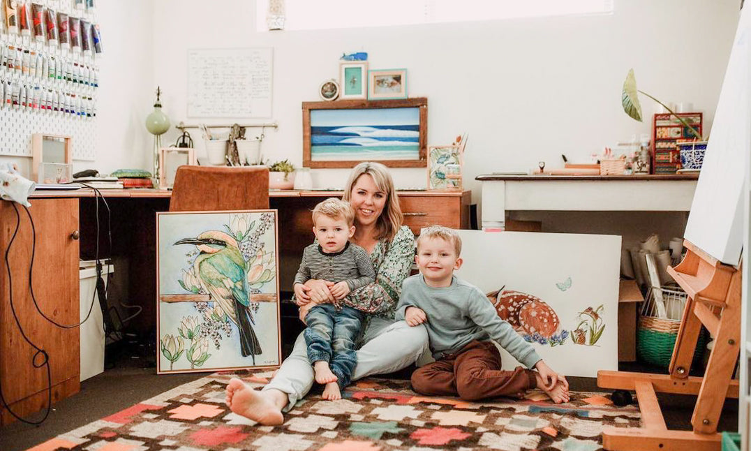 Artist Kirsten Bayes with her two children in her studio.