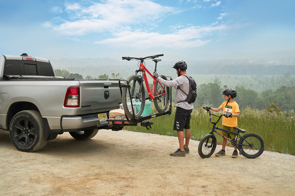 Man and child loading a bike on the mhs hitch rack