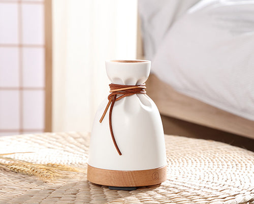 Sake Sake Humidifier in a serene bedroom setting, blending design and nature with its solid wood base​