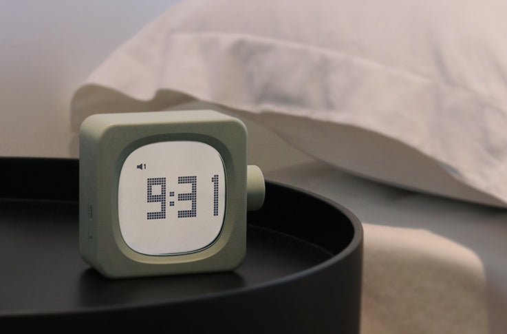 Cube Smart Alarm Clock displaying time on bedside table for easy night viewing