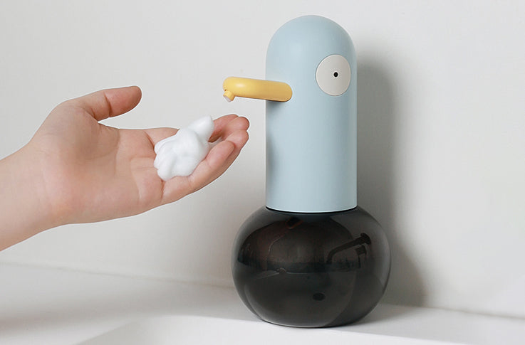 Automatic Duck Soap Dispenser dispensing foam into hand, promoting hygienic practices