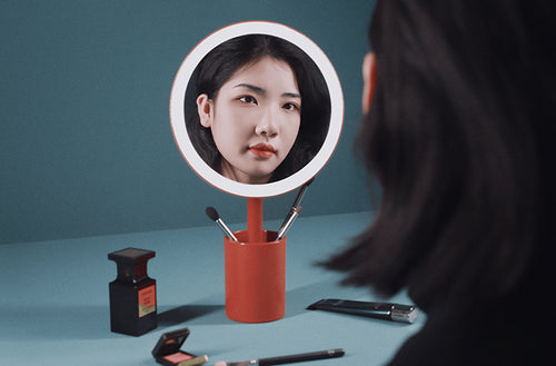 Cosmetic Mirror with brush holder in use, makeup application without light.