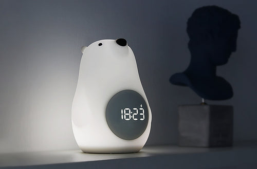Wake-Up Bear Alarm Clock showcasing the integrated night light feature in a dim room.