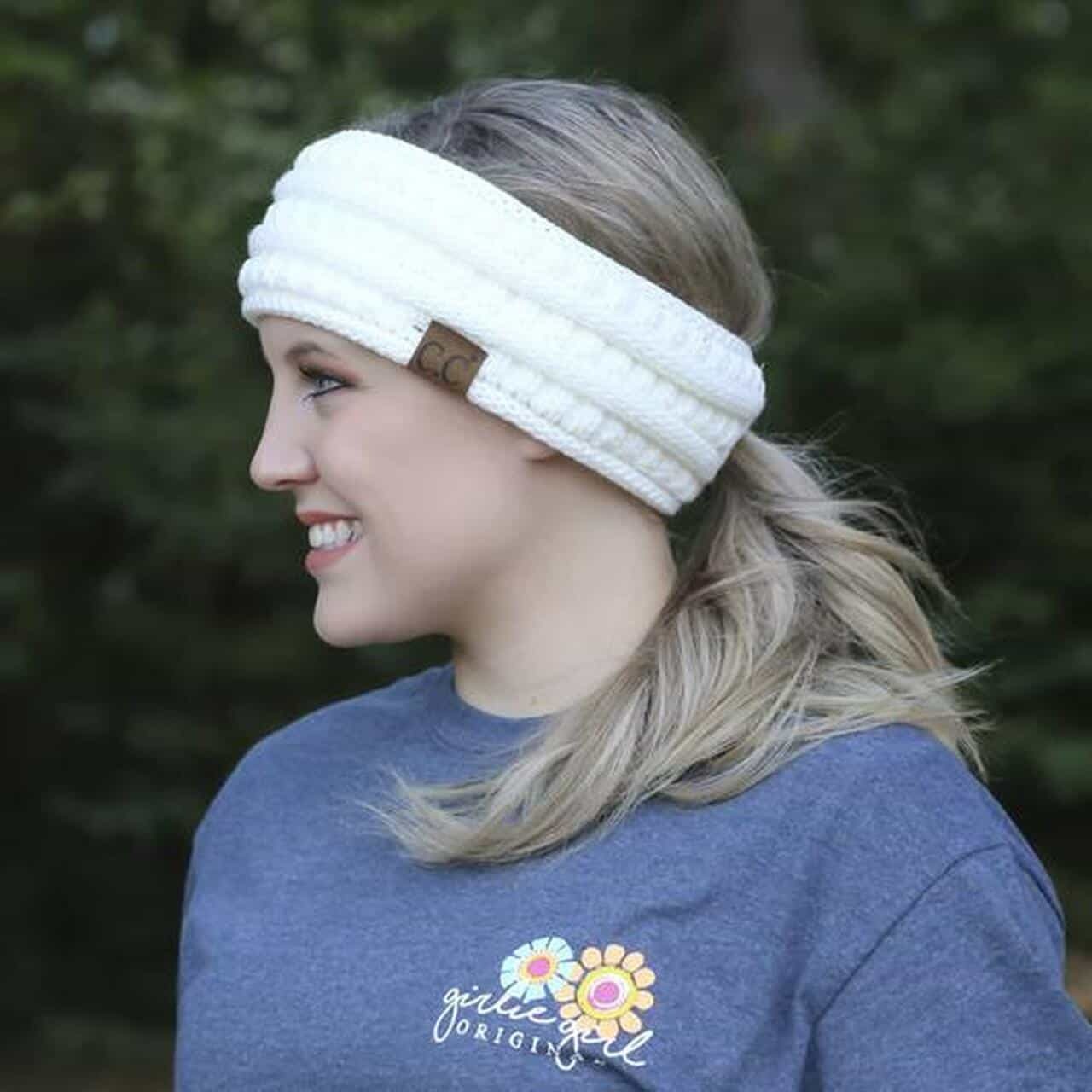 young woman wearing white knit headwrap outside