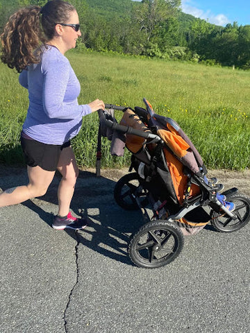 pregnant woman running while pushing stroller