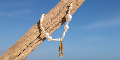 pearl bracelet on a piece of wood