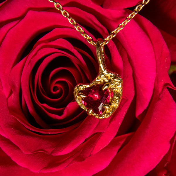 ruby pendant necklace on rose petals