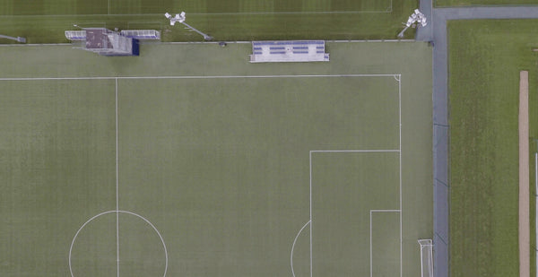 Image of a football pitch with flood lights.