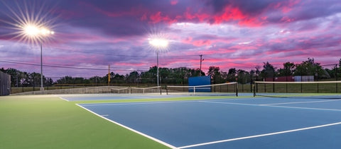 Image of tennis court with outdoor lighting.