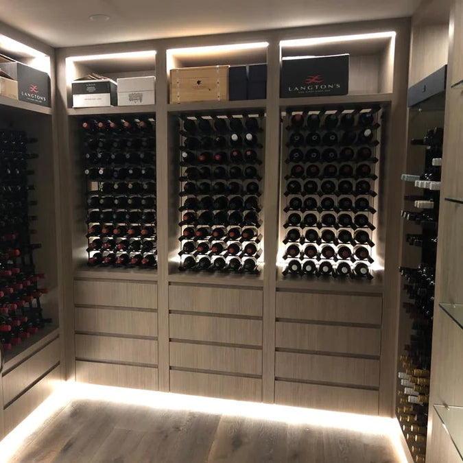 A modern cellar with wine racks and backlighting