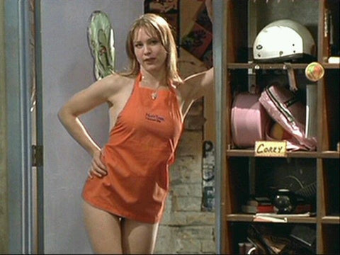 Renee Zellewegger in orange apron and no other clothes in a still from the film Empire Records