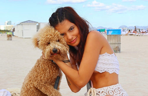 Laura Lonarc in beachwear top with dog
