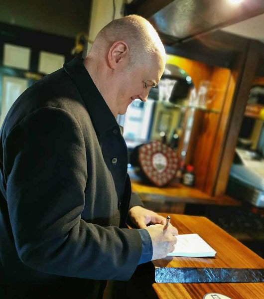 Dara Ó Briain signing autographs for us in The Little Moon pub
