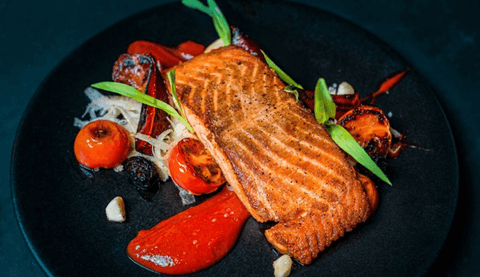 Plate with grilled salmon and assorted grilled vegetables