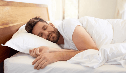 Man sleeping on his side in bed