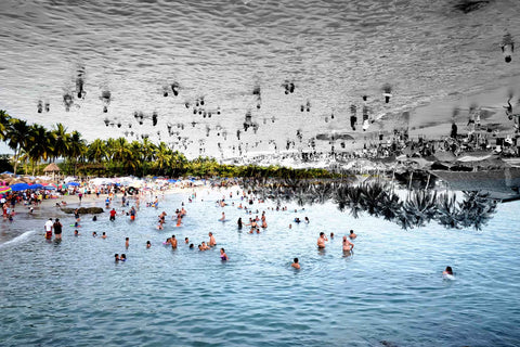 a mexicon nationals beach on the pacific coast of mexico. The image looks to be mirrored of throngs of people in the beach but the inages are different. Not mirrored. 