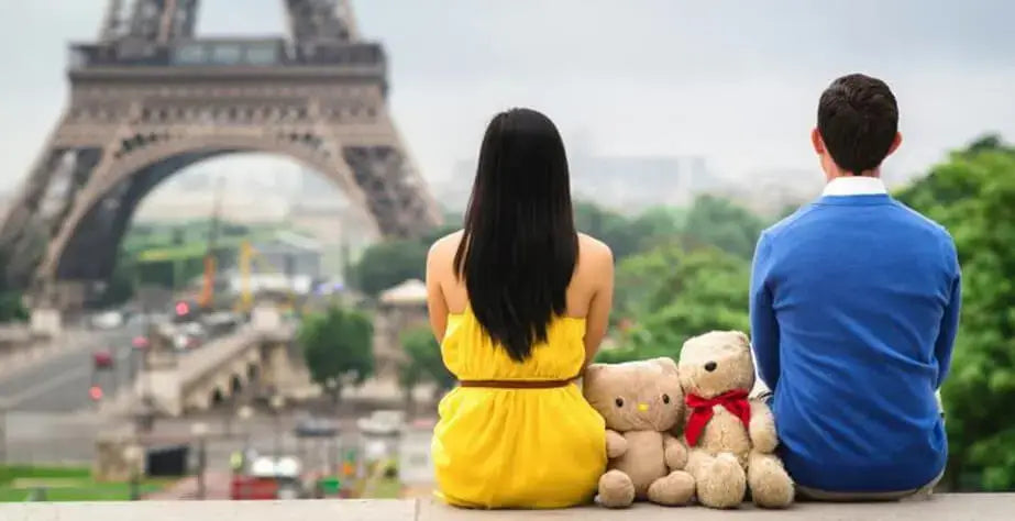 8 Reasons Why Adults Should Own Stuffed Toys- Couple and stuffed toys under the Eiffel Tower in Paris