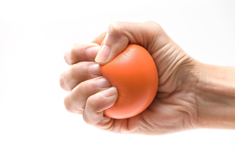 hand squeezing a stress ball