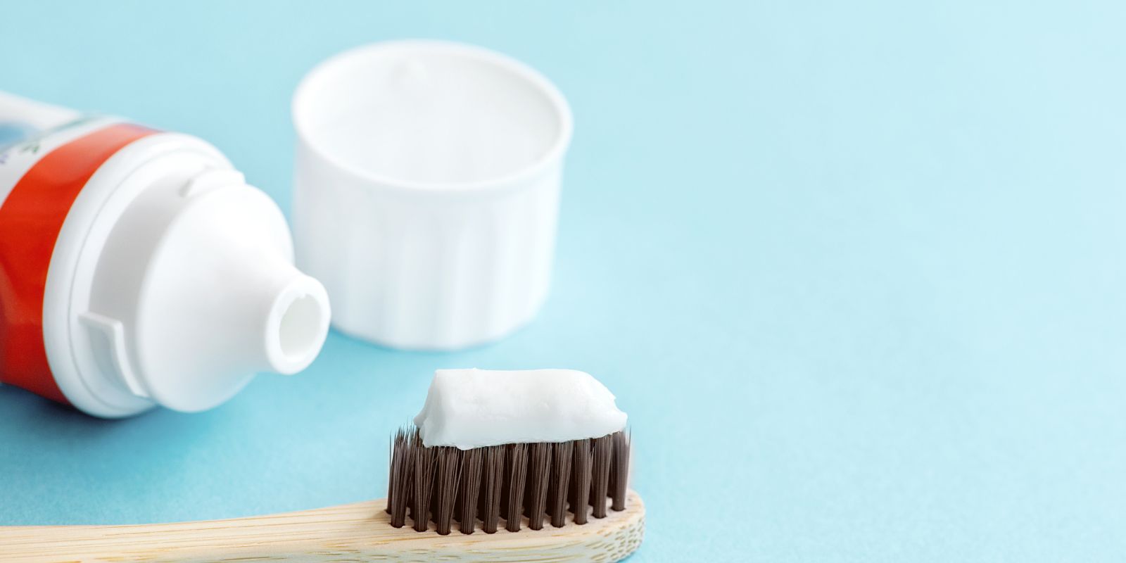 toothpaste tube and bamboo toothbrush