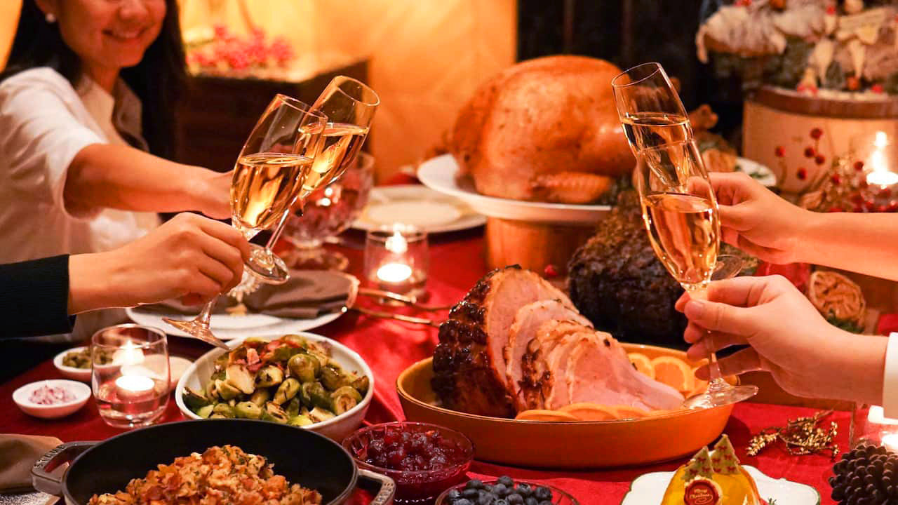 people toasting over Christmas meals