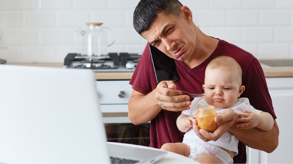 stressed man working from home in hong kong balancing with family