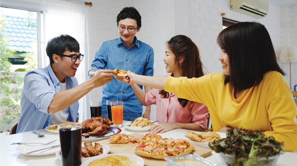 Hong kong people enjoying family dinner at home, total 4 people per table