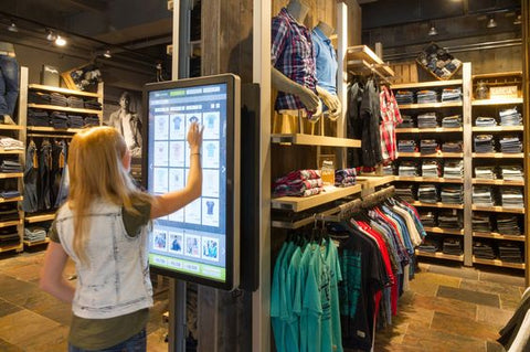 a woman looking at options at interactive mirrors