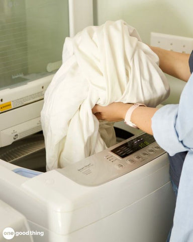 a woman washing a blouse