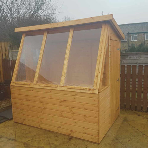 Wooden potting shed with extra long windows
