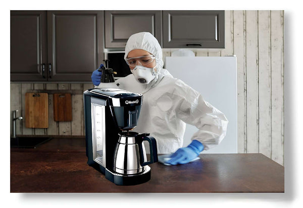 Person cleaning coffee maker in their kitchen