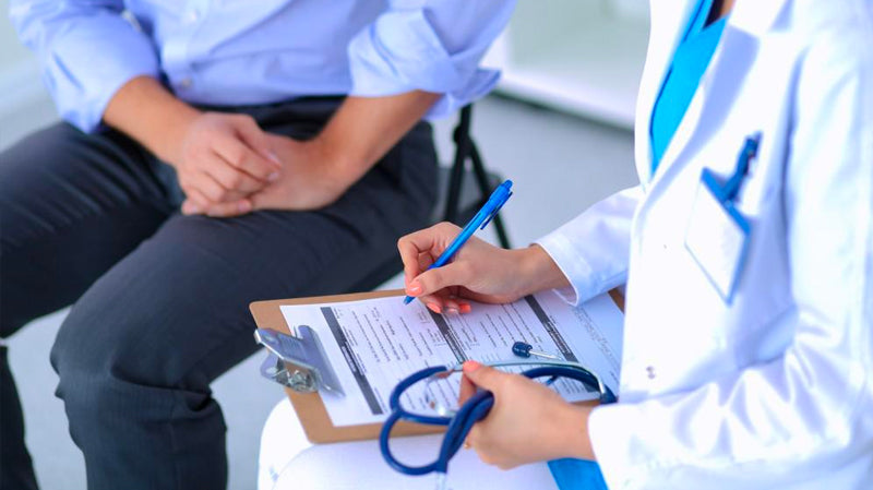 Male patient with female doctor doing regular health checkup for chronic health conditions