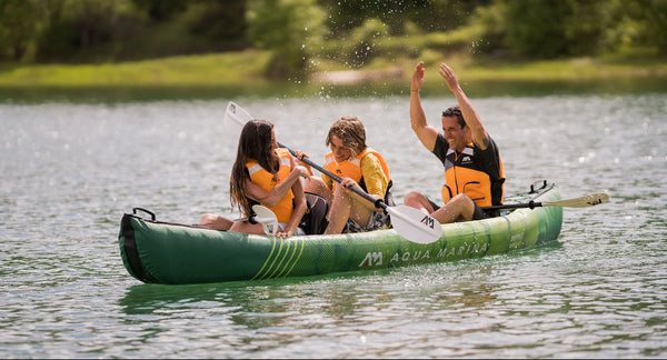 3 person inflatable kayak with 3 people paddling kayak and splashing water