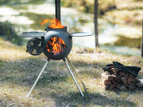 ozpig camping stove with flame on grass