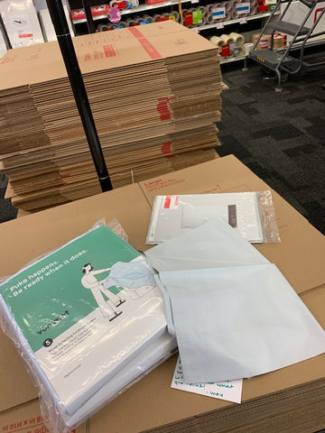 two packs of vommats on a stack of cardboard boxes at staples