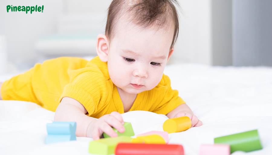 Baby boy playing with his educational gifts or toys