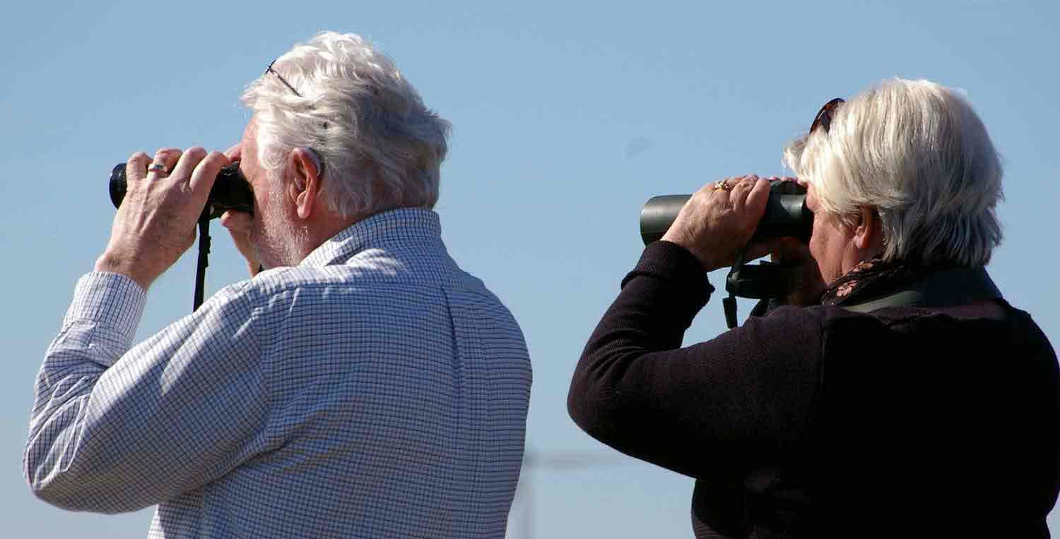 Man and woman using binoculars 