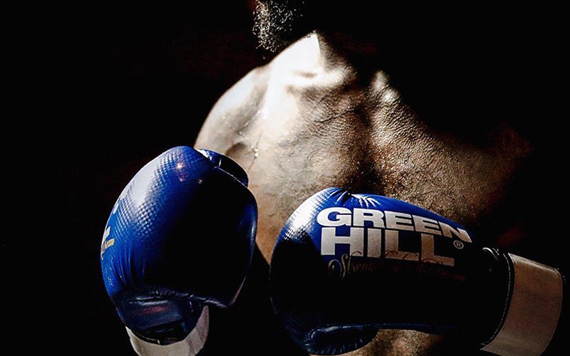 Man wearing Blue GreenHill Boxing Gloves