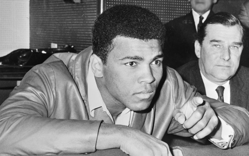 Muhammad Ali with a white man in the BG