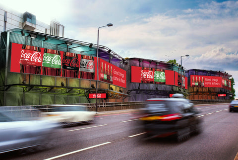 Large LED Digital Displays along a very busy highway. The LED Displays are showing an advertisement for Coca Cola.