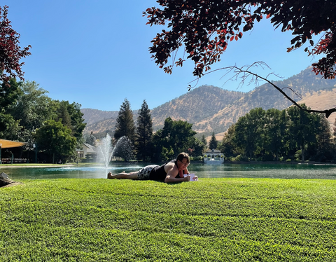 women laying on grass in california