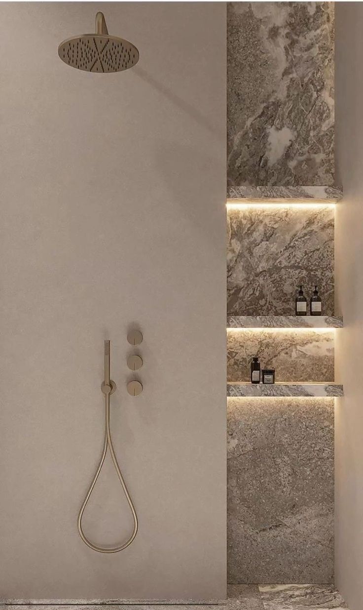 Beige rain shower with marble niche and ambient lighting