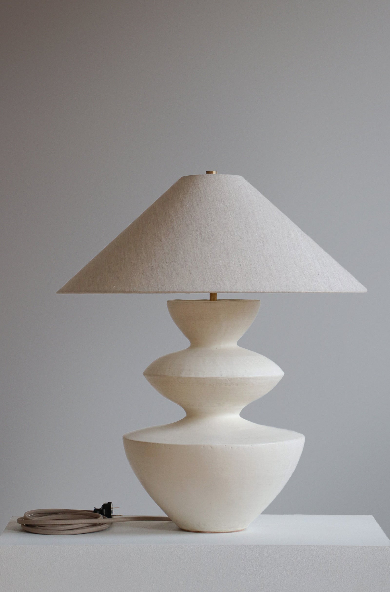 Janus Lamp in Stone Finish with oatmeal linen shade