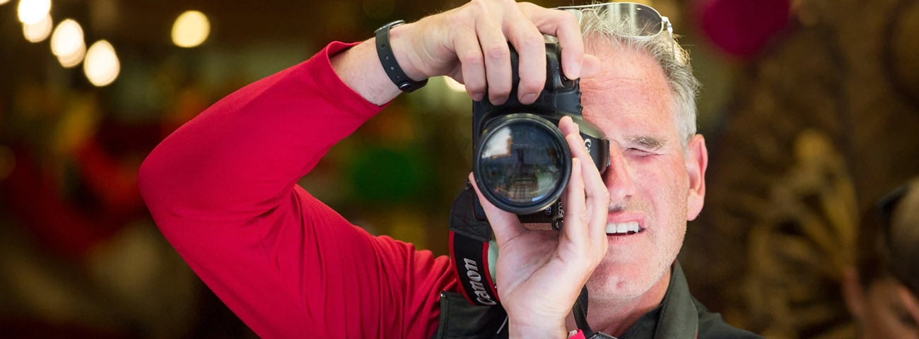 Scott Jordan holding a camera and wearing a SCOTTeVEST.