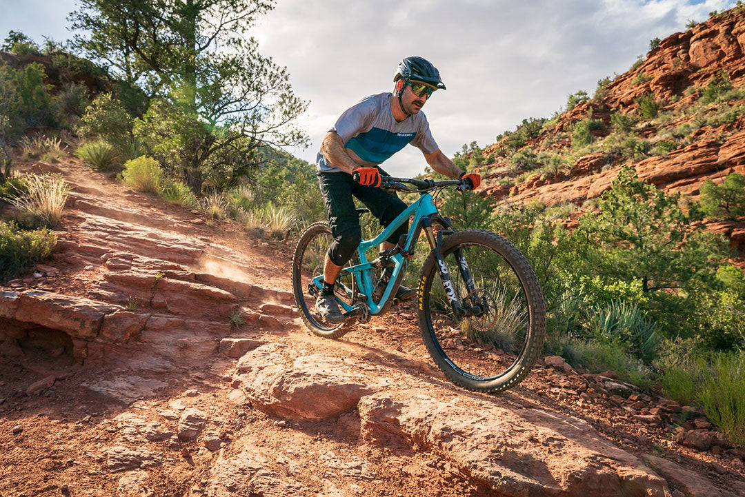 full suspension mountain biking through rough terrain