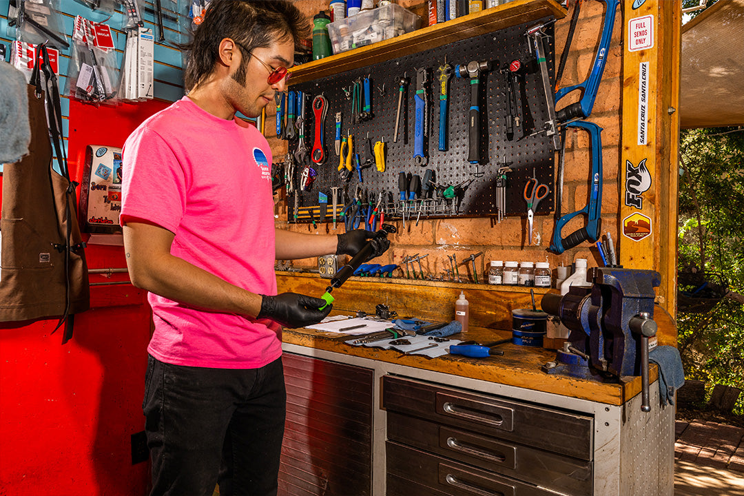 bike mechanic working on a dropper seatpost