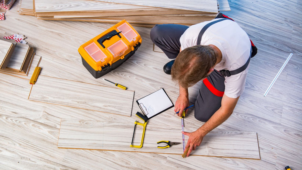man repairing hardwood flooring