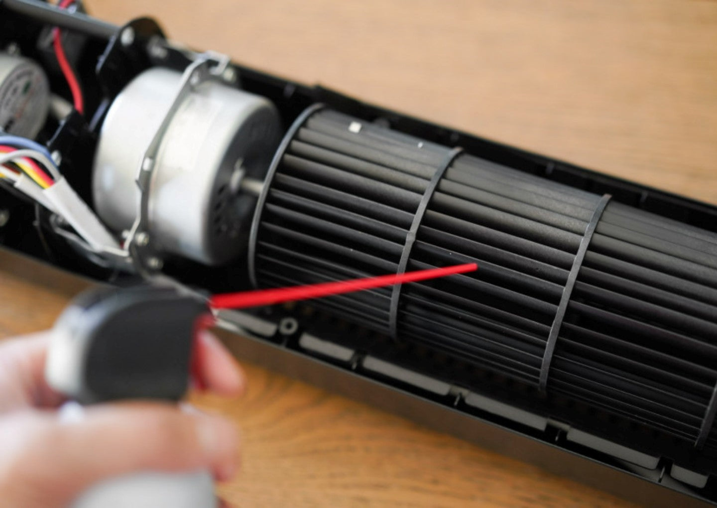 People use tool to clean the tower fan.