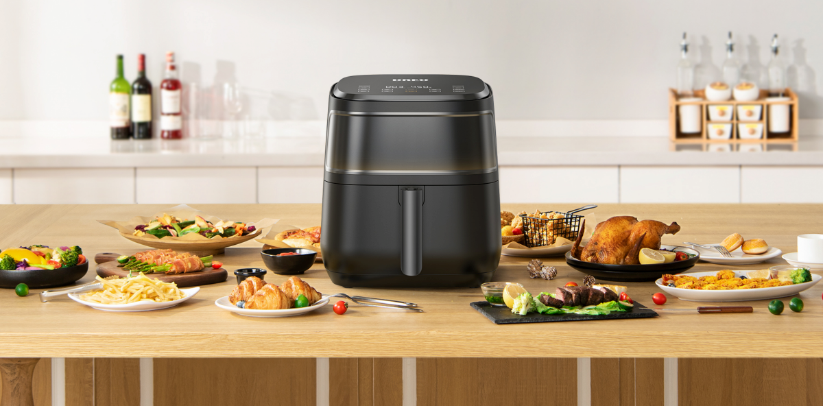 Dreo Aircrisp Pro Max air fryer with dishes on the desk