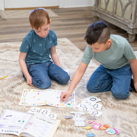 Young boys play with Pioneering Coding Set