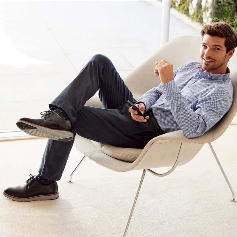 Man sitting in a button-down shirt and dress pants